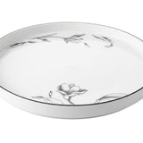 Home Sajawat white porcelain serving platter with delicate floral design and black trim.