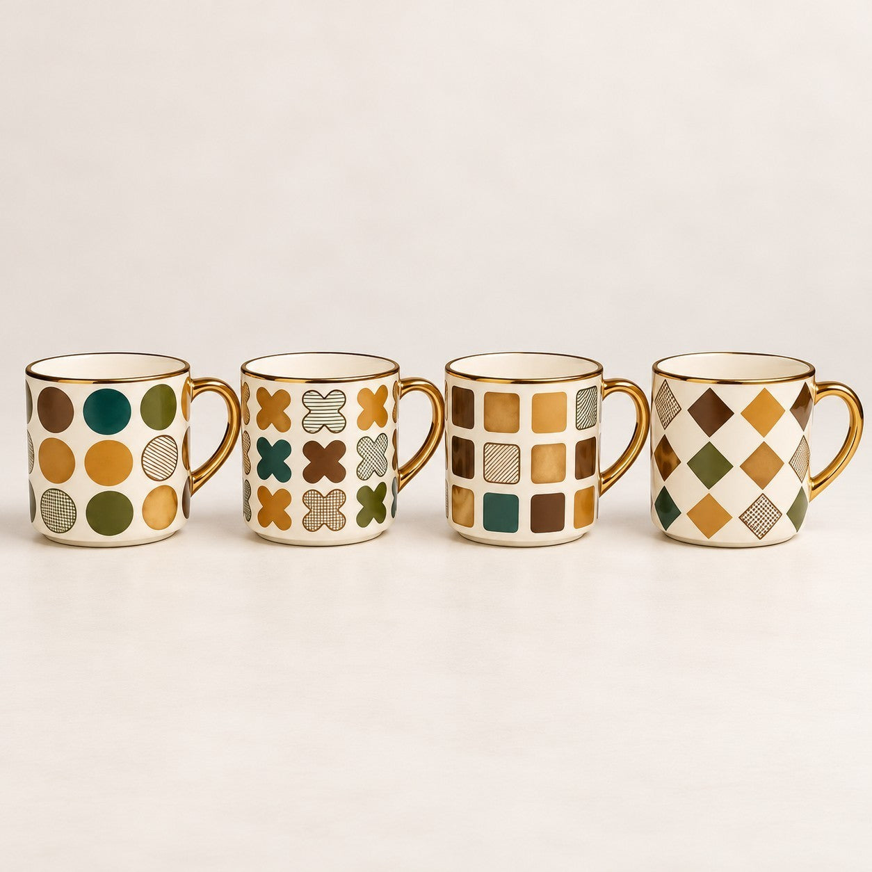 Home Sajawat set of four ceramic coffee mugs with gold rims and various geometric patterns in green and gold tones.