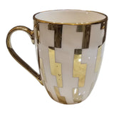 Home Sajawat ceramic coffee mug with white and gold geometric pattern and a polished gold handle.