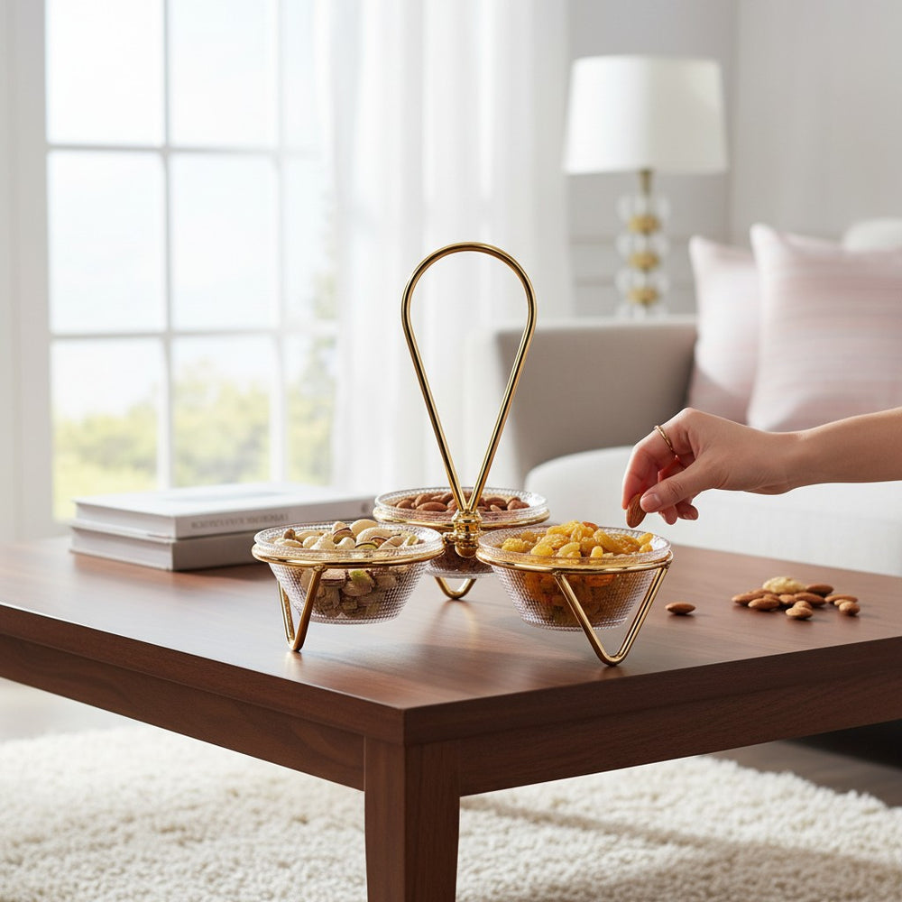Home Sajawat decorative glass serving bowl set with gold metal stand and central handle on a wooden table.