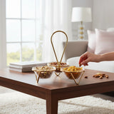 Home Sajawat decorative glass serving bowl set with gold metal stand and central handle on a wooden table.