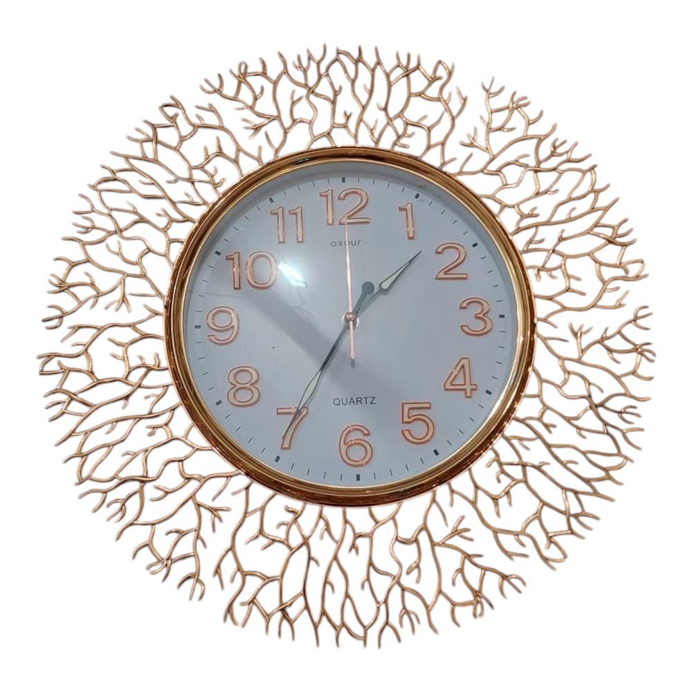 Home Sajawat gold metal wall clock with intricate branch design and white face with Arabic numerals.