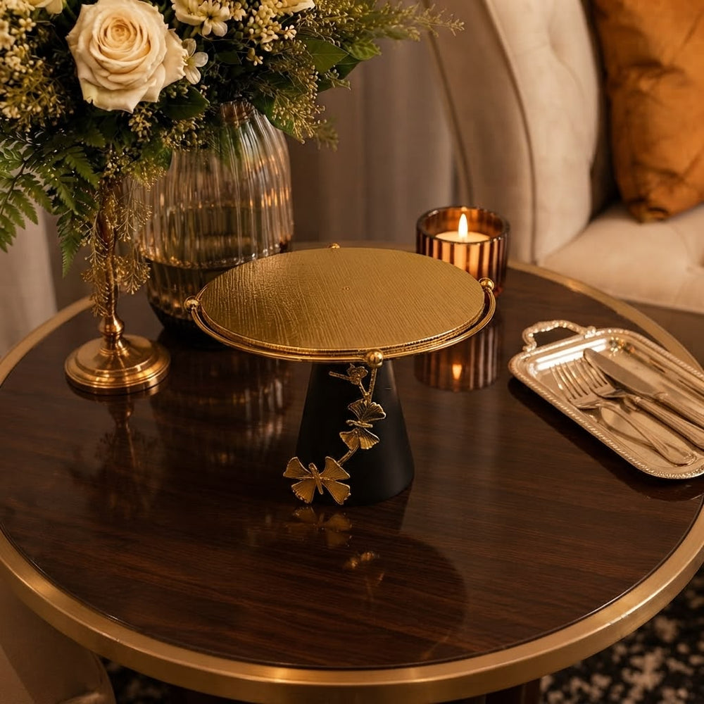 Home Sajawat decorative pedestal stand with a textured gold circular top, matte black base, and gold butterfly accents.