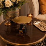 Home Sajawat decorative pedestal stand with a textured gold circular top, matte black base, and gold butterfly accents.
