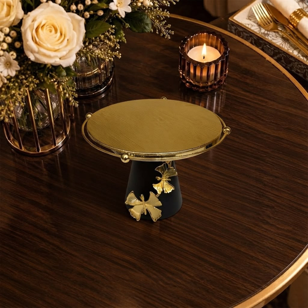 Home Sajawat decorative pedestal stand with a gold textured platform, matte black base, and gold butterfly accents.