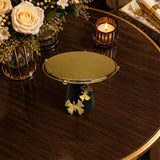 Home Sajawat decorative pedestal stand with a gold textured platform, matte black base, and gold butterfly accents.