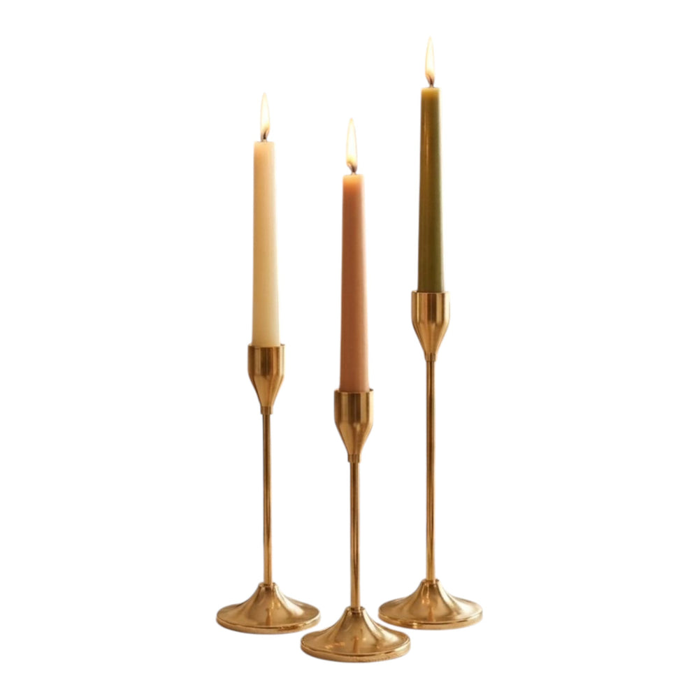 Home Sajawat set of three gold metal taper candle holders with varying heights, holding cream, blush, and olive green candles.