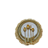 Home Sajawat gold textured charger plate with stainless steel cutlery set including fork and spoons.