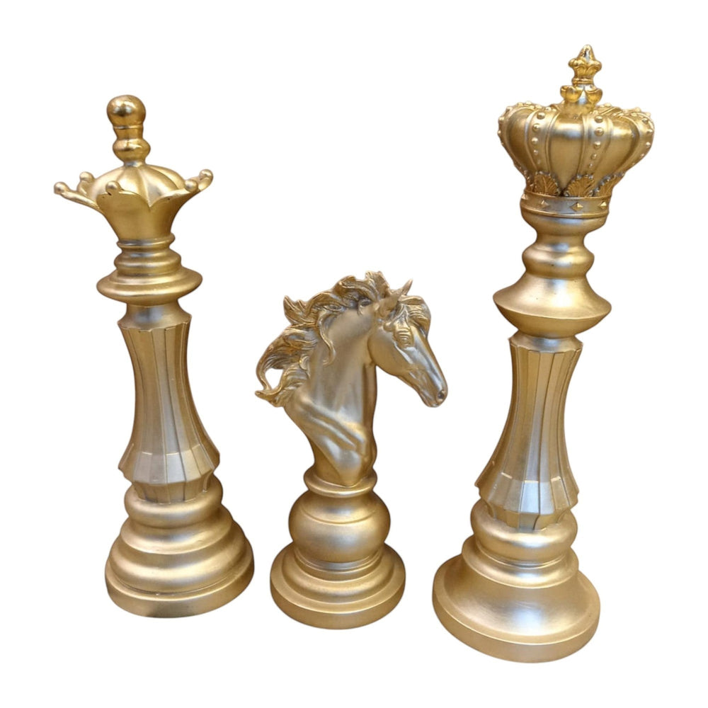 Home Sajawat gold decorative chess pieces: King, Queen, and Knight figurines with intricate detailing on bases.