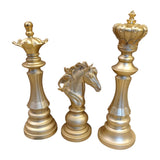 Home Sajawat gold decorative chess pieces: King, Queen, and Knight figurines with intricate detailing on bases.
