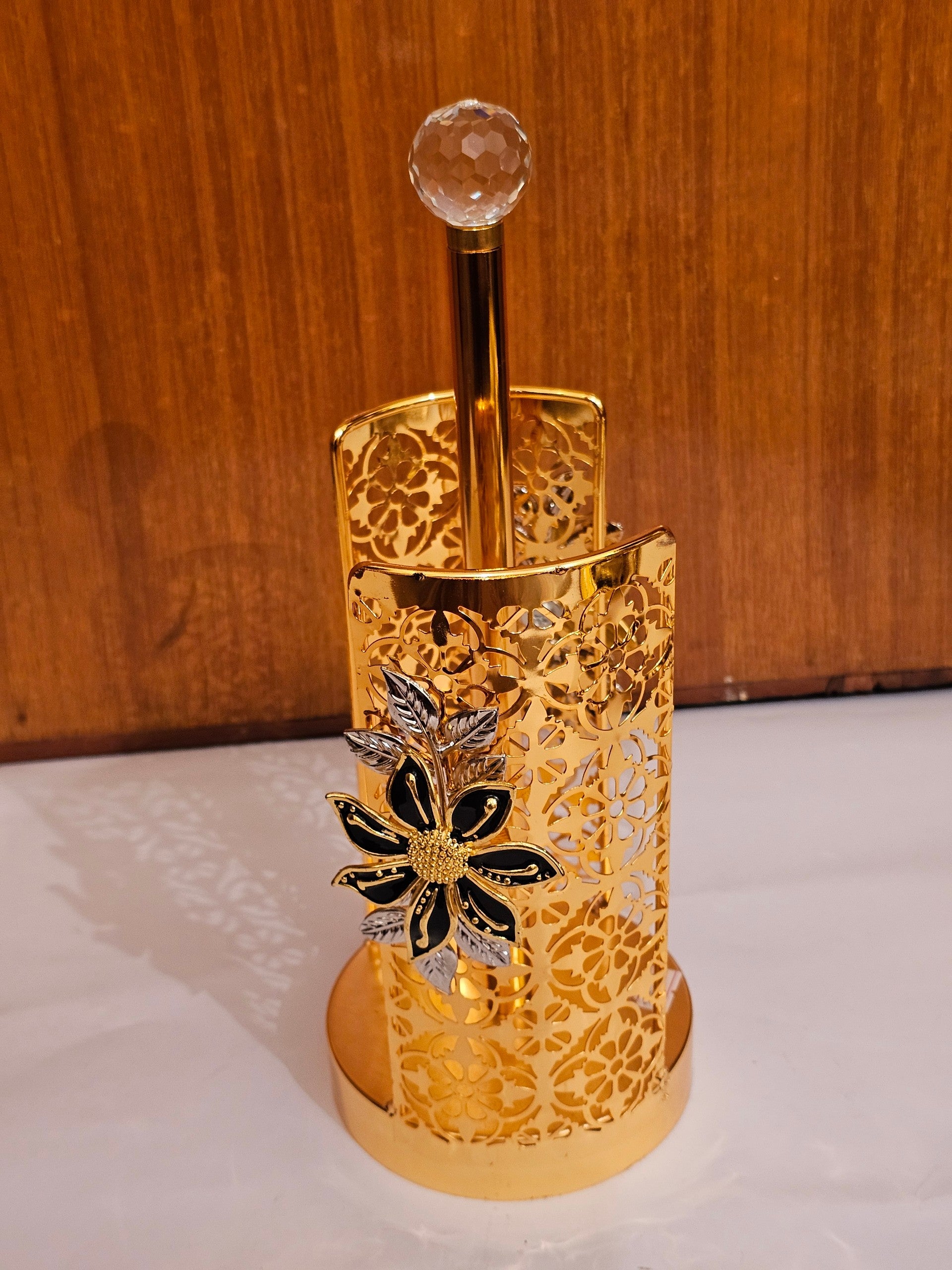 Home Sajawat gold metal paper towel holder with intricate laser-cut floral patterns and a crystal finial top