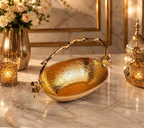 Home Sajawat gold hammered metal serving bowl with floral accents and branch-style handle on a marble table.