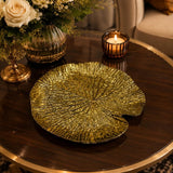 Home Sajawat gold leaf-shaped decorative charger plate with textured finish on a dark wooden table
