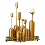 Home Sajawat decorative set of 6 gold metal taper candle holders of varying heights on an ornate tray.