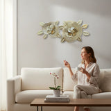 Home Sajawat gold metal flower wall art sculpture with textured centers and metallic leaves. Two openwork floral designs.