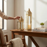 Home Sajawat gold metal Moroccan-style lanterns with intricate cut-outs and glass panels. Set of two.