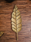 Home Sajawat gold metal leaf tray with hammered texture and intricate vein detailing on a wooden surface