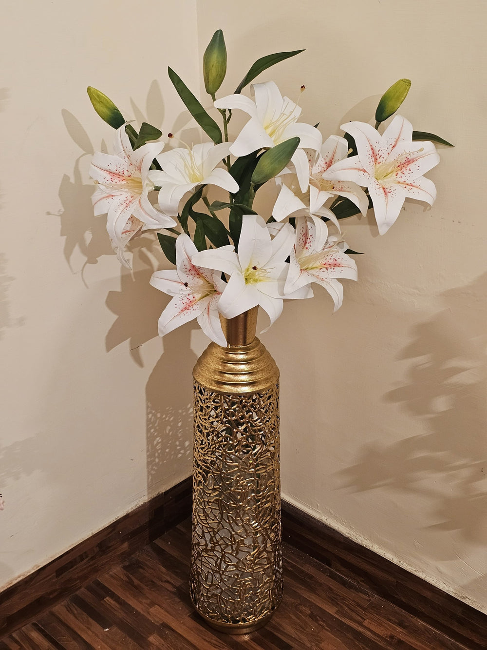 Home Sajawat artificial white lily arrangement with pink speckles in a tall, gold-toned laser-cut metal floor vase.