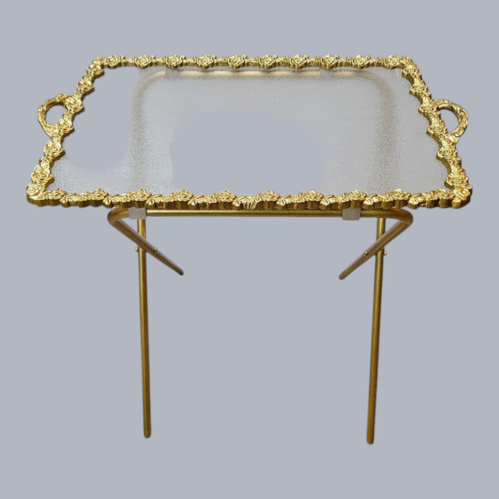 Home Sajawat ornate gold-tone serving tray with mirrored surface and foldable legs, featuring rose motifs and integrated handles.