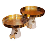 Home Sajawat set of two gold textured pedestal serving trays with white bases and decorative gold butterfly accents.