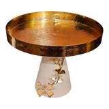 Home Sajawat gold textured pedestal serving tray with a white base and decorative gold butterfly accents.