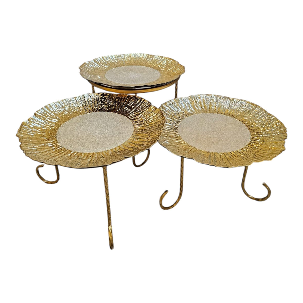 Home Sajawat set of three decorative gold tiered serving stands with textured plates and twisted metal legs.