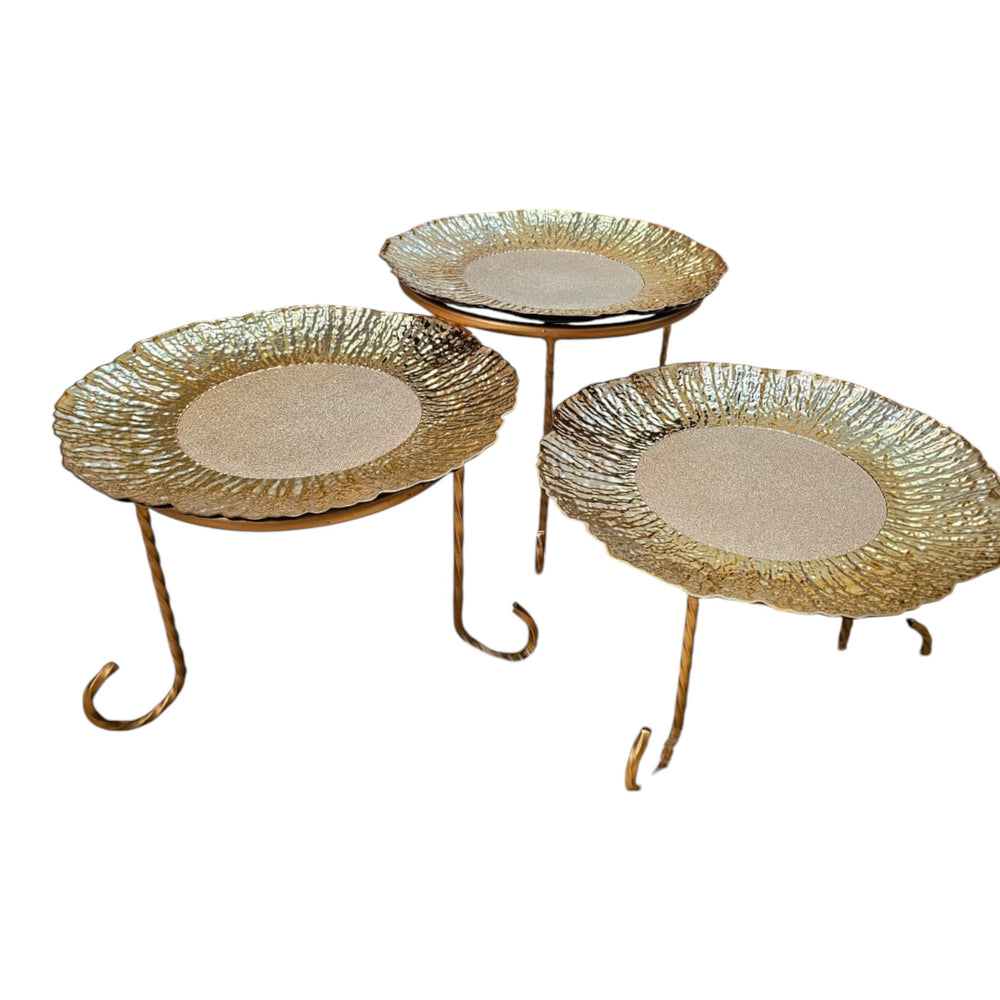 Home Sajawat set of three decorative gold tiered serving stands with textured plates and twisted metal legs.