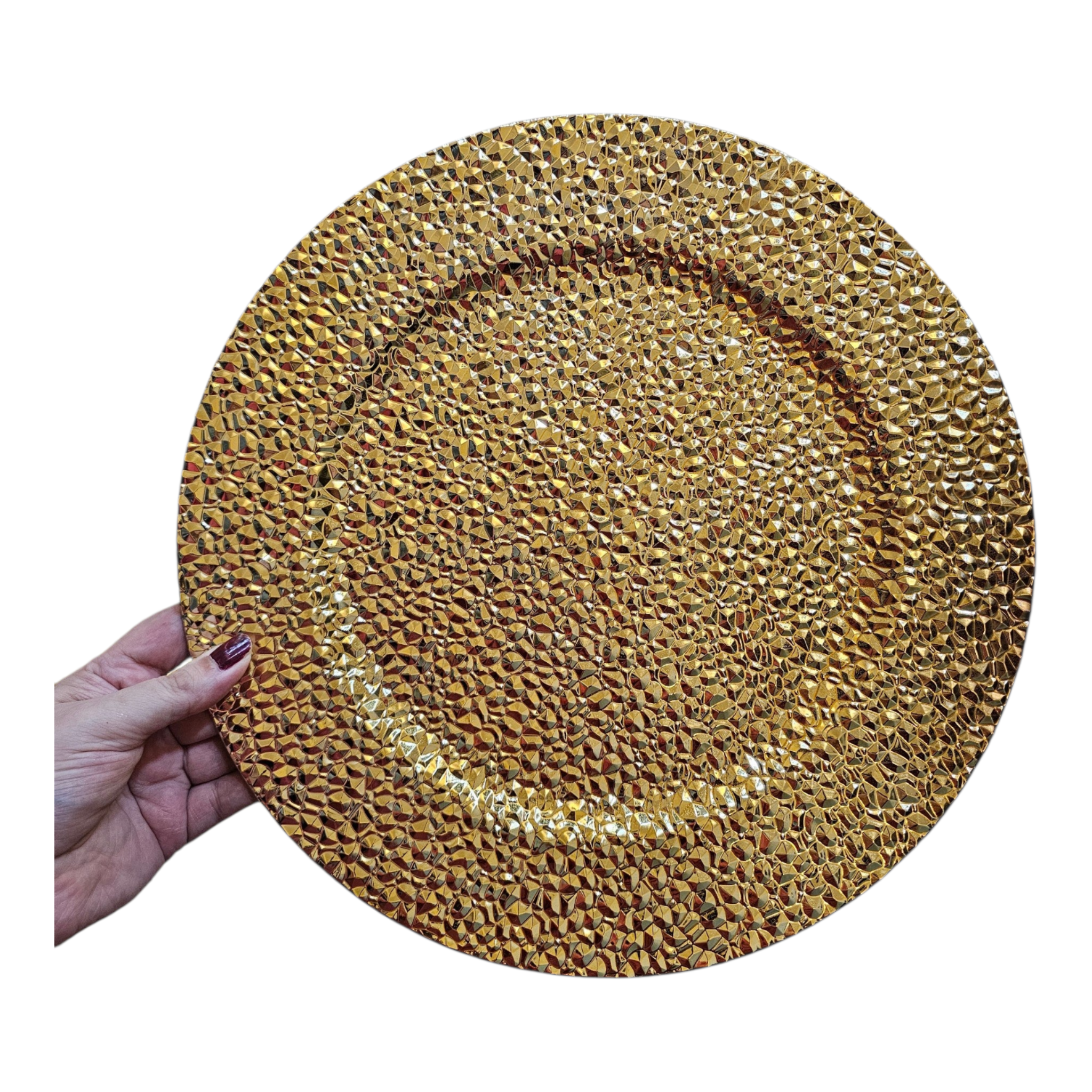 Home Sajawat gold decorative charger plate with a textured, faceted surface held by a hand for a formal table setting.
