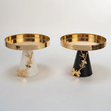 Home Sajawat decorative gold tray with butterfly accents on conical base, available in matte black or ivory.