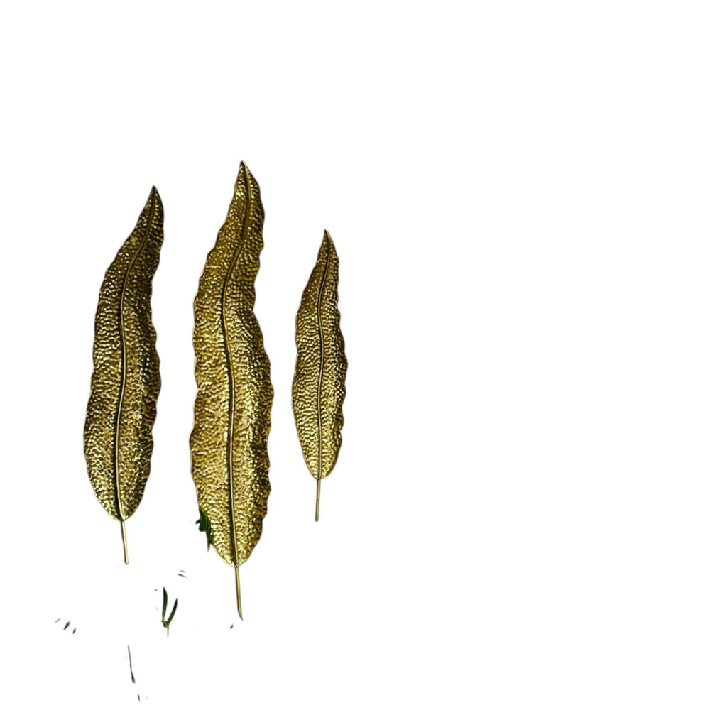 Home Sajawat set of three textured golden leaf wall art pieces. Metallic finish, natural elegance, sophisticated shine.