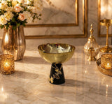 Home Sajawat decorative pedestal bowl with a hammered gold finish and black conical base featuring floral accents.