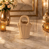 Home Sajawat handbag shaped ceramic tabletop vase in a neutral matte finish on a marble surface