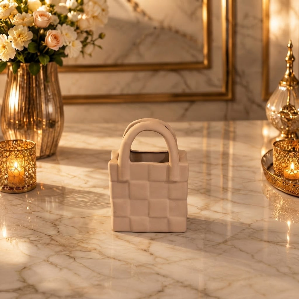 Home Sajawat handbag shaped ceramic tabletop vase in a neutral matte finish with a textured woven pattern