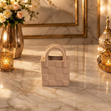 Home Sajawat handbag shaped ceramic tabletop vase in a neutral matte finish with a textured woven pattern