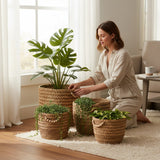 Home Sajawat handwoven seagrass storage basket set with wooden bead accents, styled with indoor plants in a living room.