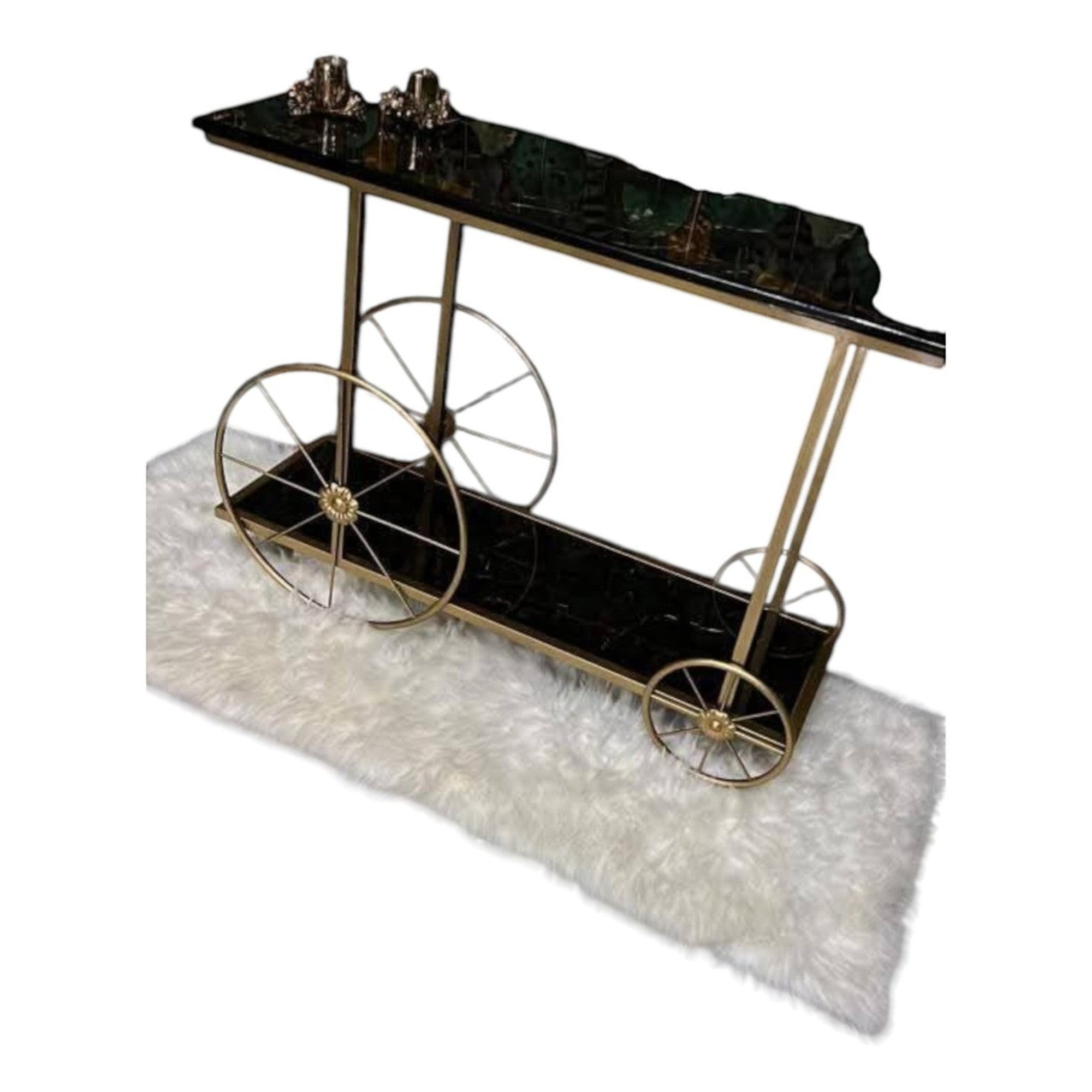 Home Sajawat black marble-effect serving cart with gold metal frame and decorative wheels.