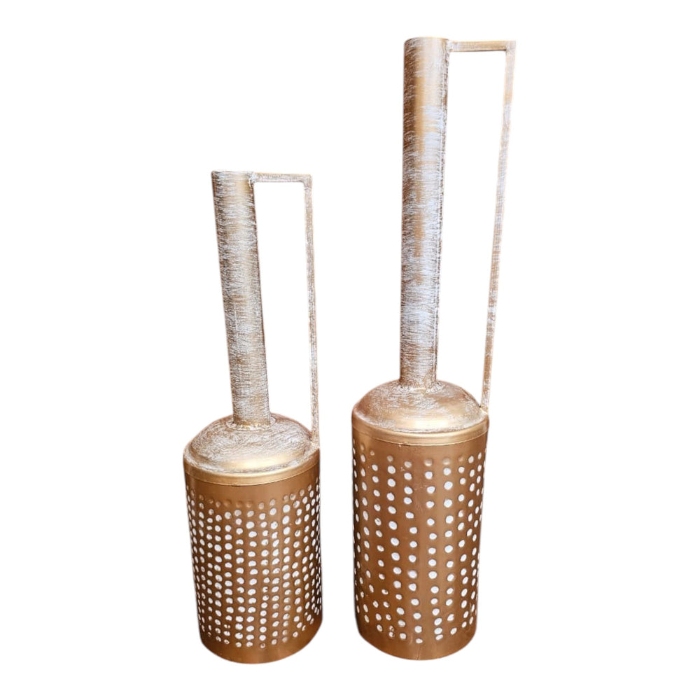 Home Sajawat set of two antique gold metal lanterns with white distressed necks and perforated cylindrical bases. Features handles.