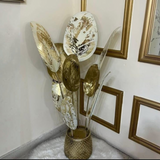 Home Sajawat decorative metal floor sculpture featuring oversized gold and white leaf plates on a textured gold base.