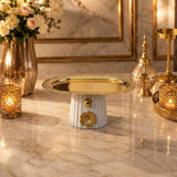 Home Sajawat decorative pedestal serving tray with a white fluted ceramic base and polished gold-tone metal top.