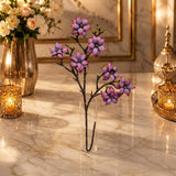 Home Sajawat artificial purple magnolia branch in a clear glass vase on a marble table with warm ambient lighting