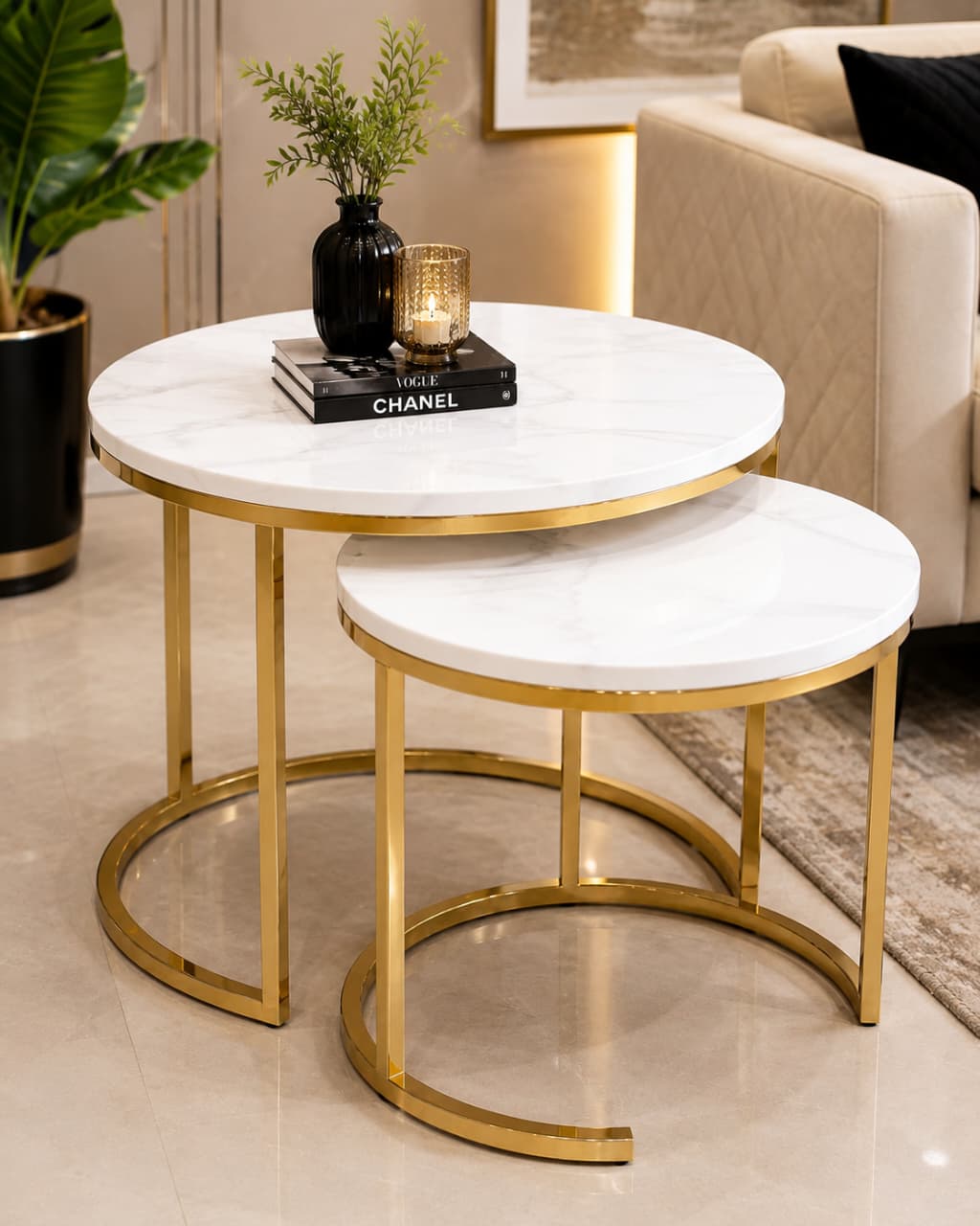 Home Sajawat modern round nesting coffee table set with white faux marble tops and gold metal frames in a living room