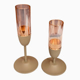Home Sajawat set of two modern stemmed candle holders with matte beige bases and copper-accented glass cylinders.