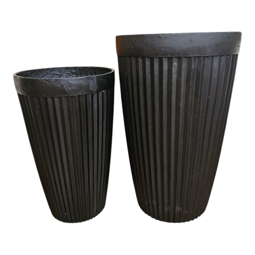 Home Sajawat tall faux potted plant in a ribbed black planter. Realistic green leaves and branches add natural beauty without maintenance.
