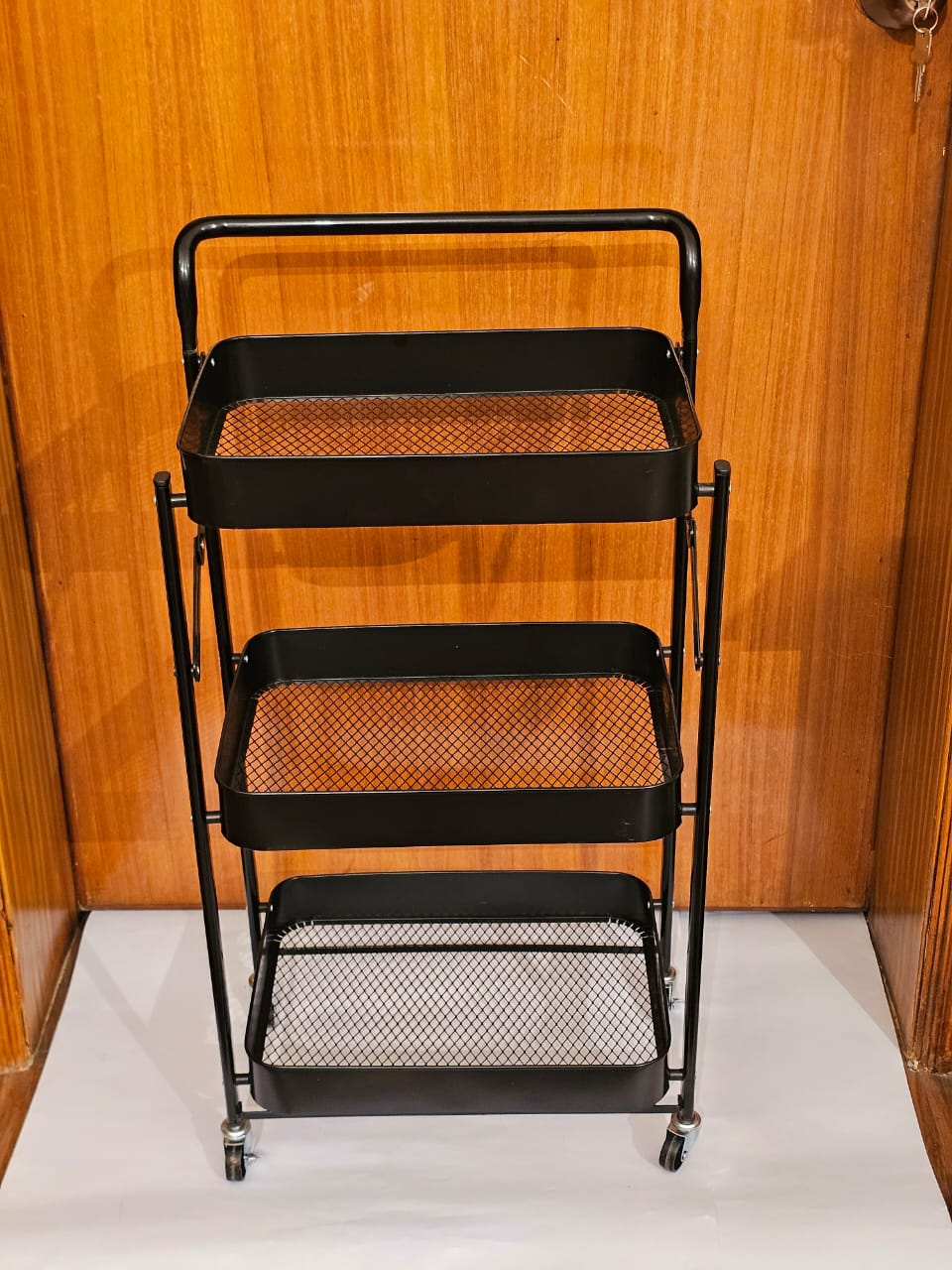 Home Sajawat matte black 3-tier rolling utility cart with mesh shelves and swivel casters for home organization.