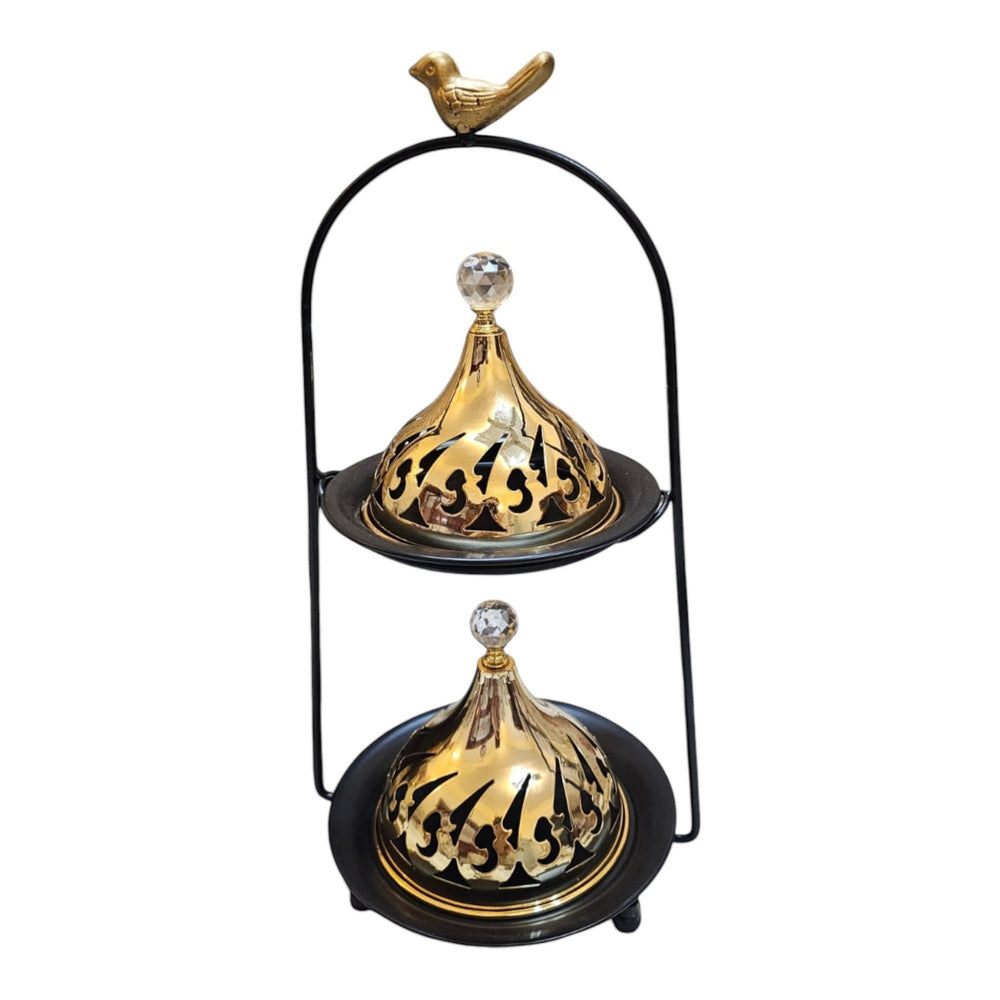 Home Sajawat two-tiered gold incense burner with cut-out lids, crystal finials, and bird accent on black stand.
