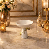 Home Sajawat white ceramic pedestal bowl with gold floral accents on a marble table centerpiece
