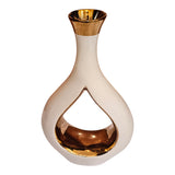 Home Sajawat modern ceramic vase with a glossy white exterior and reflective gold interior in a hollow-center shape.