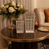 Home Sajawat set of two white metal lanterns with lattice design and rustic rope handles on a dark wood table