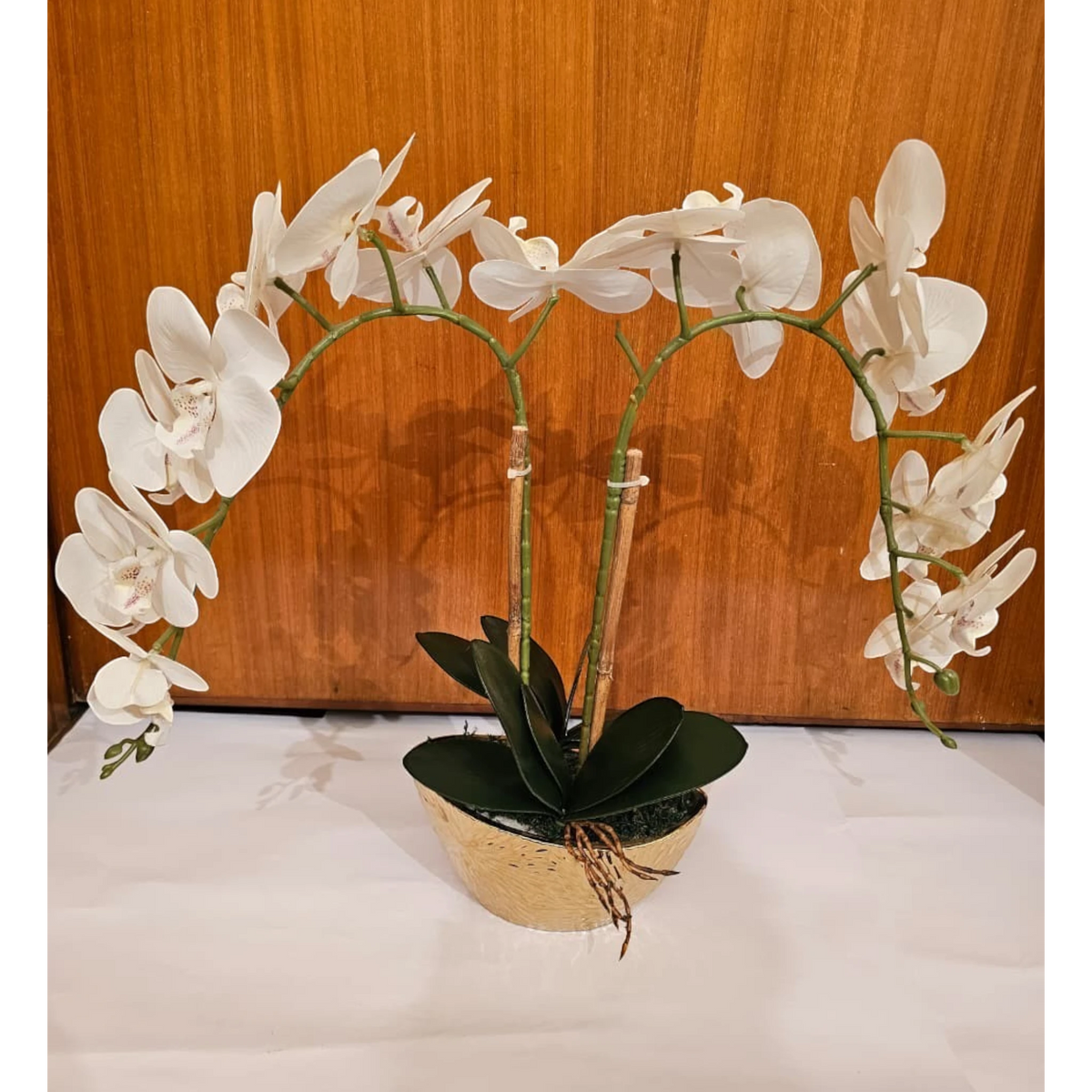 Home Sajawat artificial white Phalaenopsis orchid with two arching stems in a textured gold ceramic pot.
