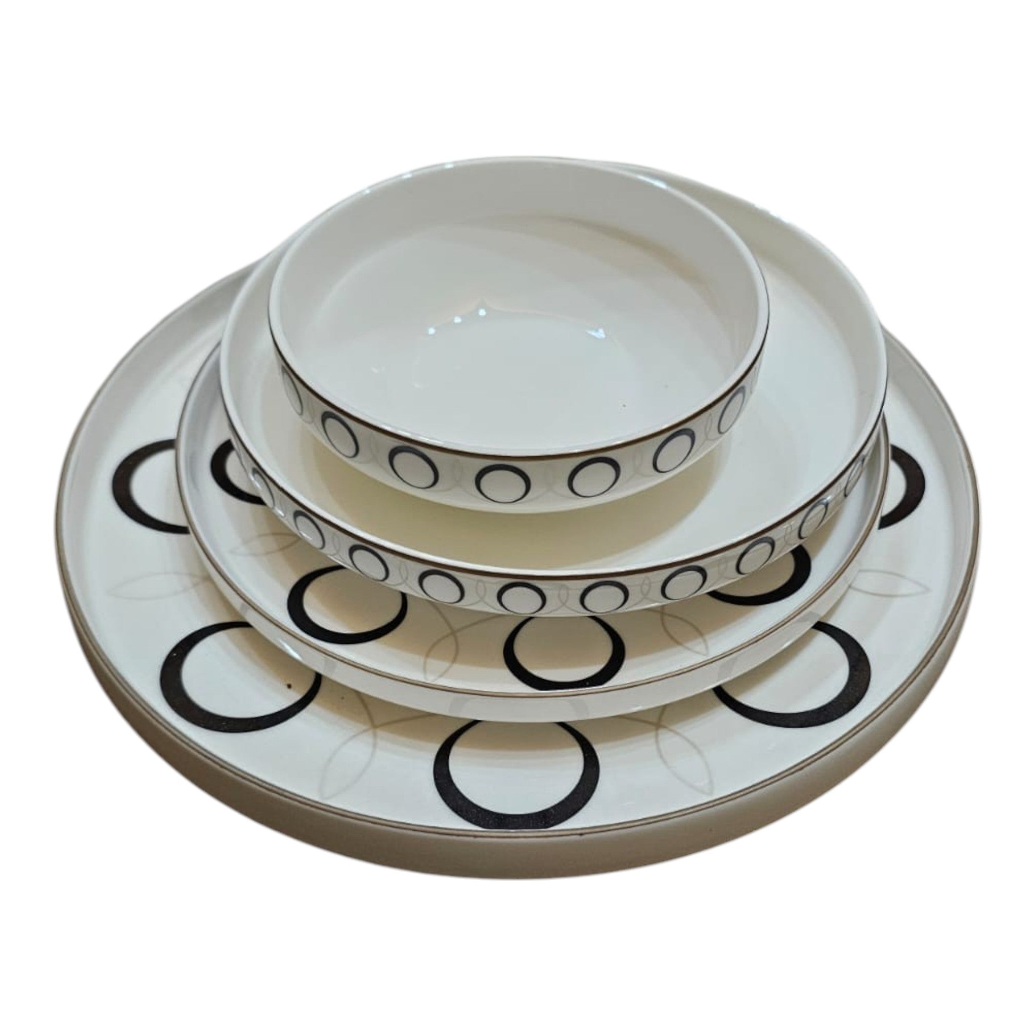 Home Sajawat white ceramic dinnerware set with black geometric circles and gold rim. Includes plates and bowls.